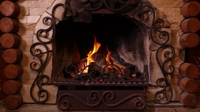 Wood burning in fireplace at home. Cozy atmosphere