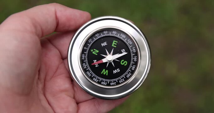 Man with compass outdoors, above view. Camera tracking