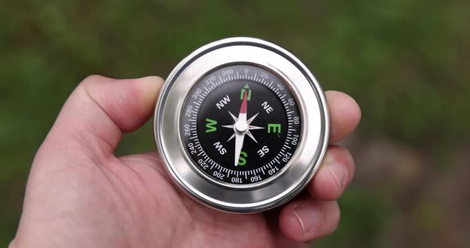 Man with compass outdoors, above view. Camera tracking