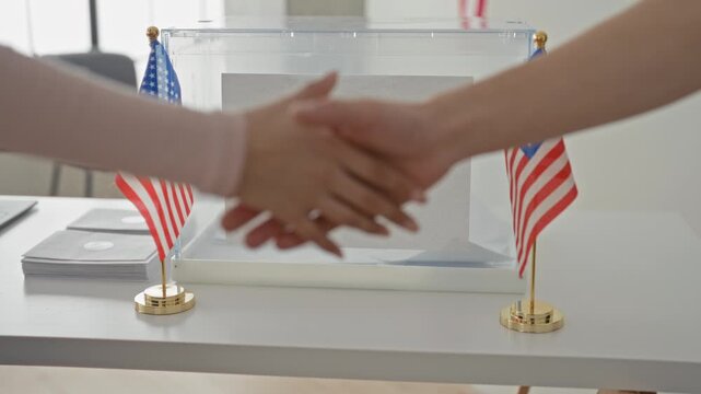 Man and woman shake hands at voting booth in building near us flags and ballot box; civic duty trust collaboration.