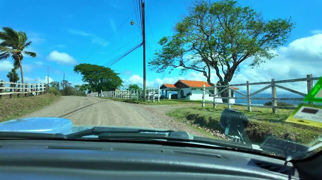 Driving a car on a rural dirt road in the countryside