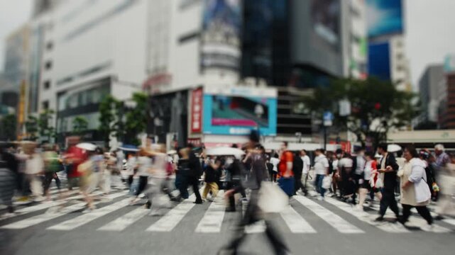 Anonymous crowd of people walking on busy crosswalk in tokyo