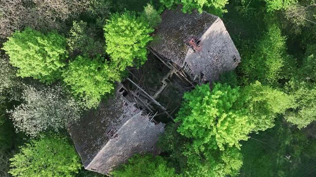Aerial ruins historic manor house Poland descend inside 1. Drawsko northern Poland. Farm manor house in rural country farming landscape and economy. Abandoned after a century use, wealthy land owner.
