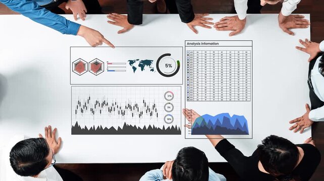 Group of professionals analyzing business data on table with charts, graphs, and statistics during corporate meeting in modern office setting Gluon.