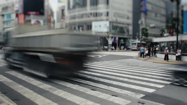 People and cars crossing the busy shibuya intersection in tokyo