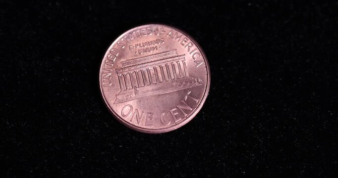   American one cent coin on black velvet, an old one-cent coin on a black soft surface, close up