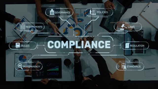 A diverse group of professionals collaborates at a business meeting focused on compliance, governance, and regulations, surrounded by charts and technology. Raster