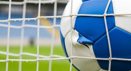 Naklejka premium Soccer ball in goal net, close up