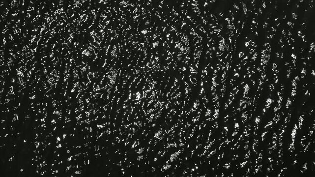 Dazzling flickering light spots similar to river surface reflection, dizzy abstract background footage.