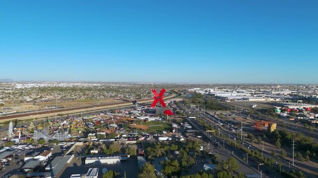 Ciudad Juarez, Chihuahua, featuring the monumental red "X" sculpture. The scene its located near the Rio Grande, symbolizing the intersection of cultures at the international border with the USA.