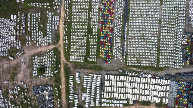 Aerial View of Vehicle Storage Yard with Rows of Parked Cars
