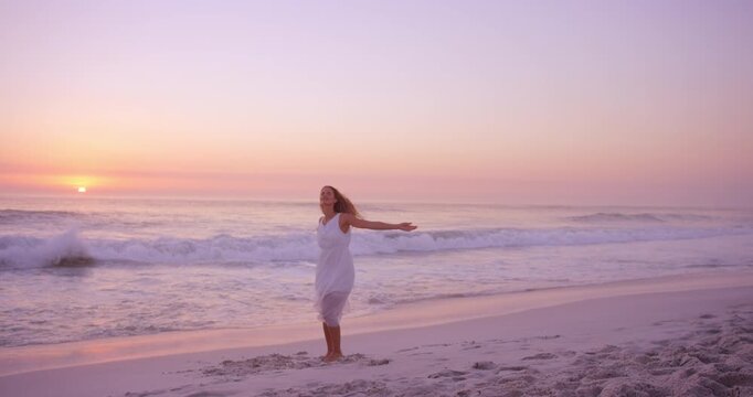 Travel, sunset or woman at seaside with dancing, carefree or peaceful perspective on ocean vacation. Space, beach waves or tourist with movement, calm mindset or summer evening on holiday break.