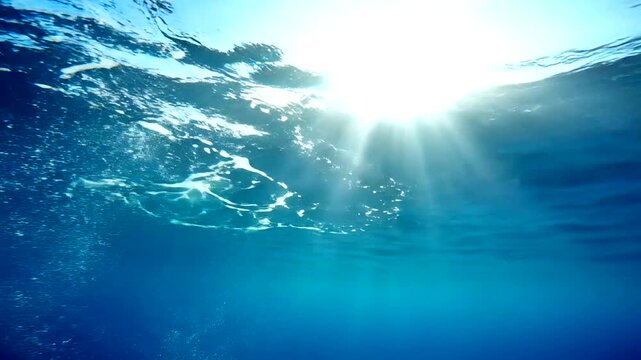 Sunlight Filtering Through Ocean Waves Underwater.
