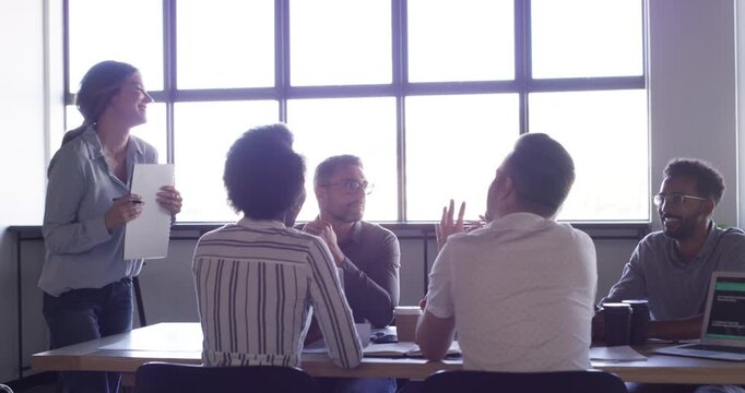 Team leader, group meeting and happy woman, business people and chat in morning briefing, daily report or sales feedback. Project manager, collaboration and workforce consulting on work, idea or plan