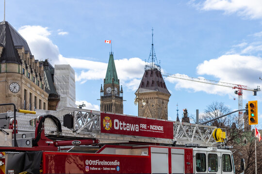 Ottawa, Canada - April 6, 2024: Ottawa fire truck with parliament buildings in Ottawa downtown