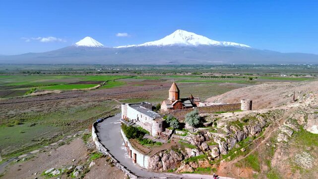 Aerial view of Khor Virap monastery with its stone walls and conical roof against the snow-capped peaks of Mount Ararat in Pokr Vedi, Ararat Province, Armenia.