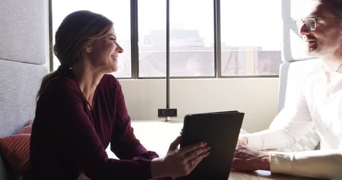 Coworking, tablet and professional people conversation, discussion and teamwork on project development. Business cooperation, meeting plan or partner talking about feedback, research or online report