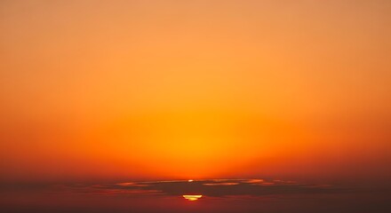 Obraz premium Sunset illuminates the horizon with warm orange light rays.