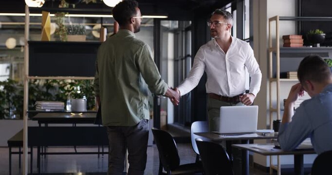 Laptop, team and handshake of business people, welcome to corporate company or greeting. Meeting, shaking hands and group introduction on computer in discussion, consultant partnership or negotiation