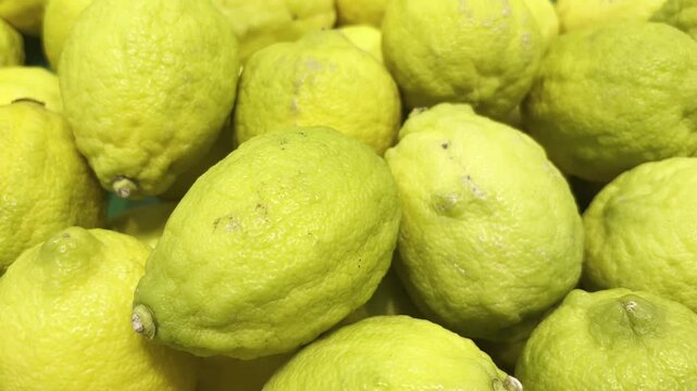 Fresh Green Citrus Fruits. Full Frame Close-up of Vibrant Organic Produce. Healthy Culinary Ingredient.