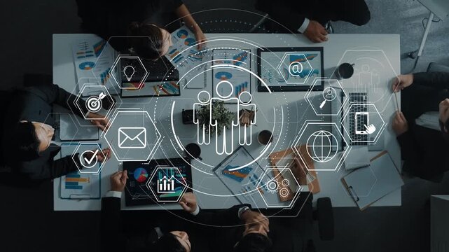 Overhead view of a diverse group of professionals in a business meeting using digital tools, analyzing data with charts and collaborating on innovative ideas for growth. Raster