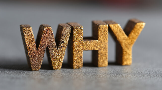 Word WHY in textured golden wooden letters standing on a grey stone surface, purpose and reason concept.