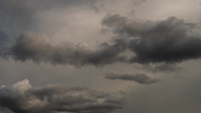Dark thunderstorm clouds rainny season. Meteorology danger windstorm disasters climate. Banner Dramatic dark storm clouds black sky background. Dark thunderstorm clouds rainny atmosphere.