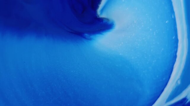 Paint drop explosion. Acrylic spill. Blue violet white enamel mixing spreading abstract background. Blur color art steam blend dye.
