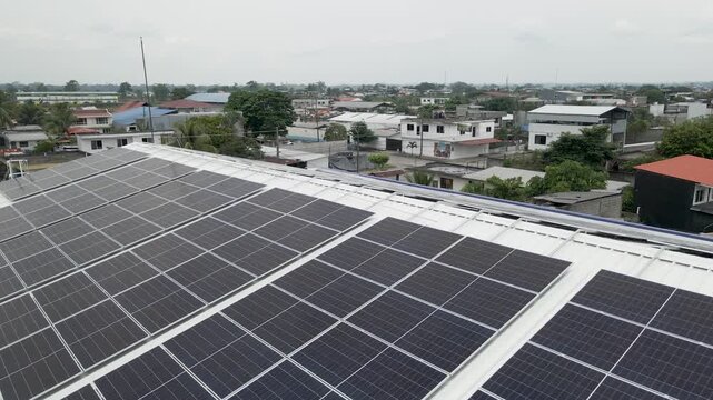 Solar panels installed on industrial warehouse roof generating renewable energy