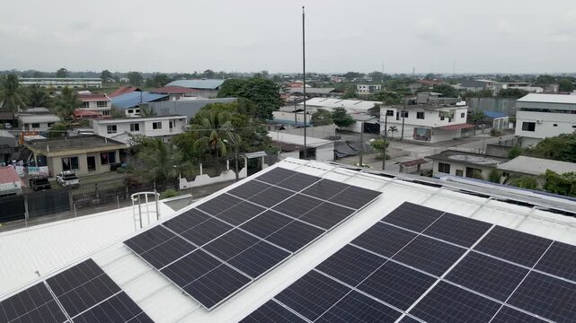 Solar panels installed on industrial warehouse roof generating renewable energy