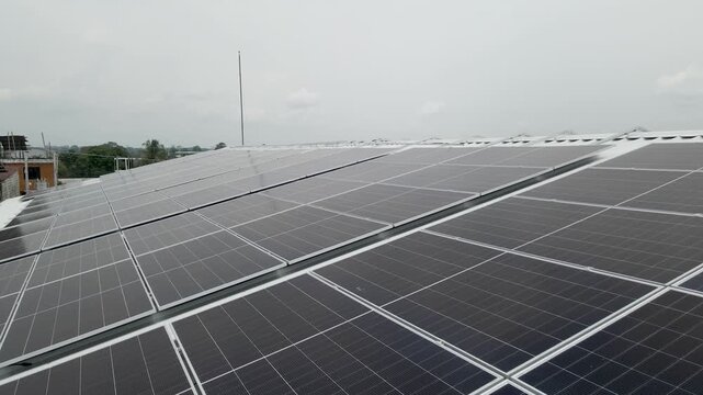 Solar panels installed on industrial warehouse roof generating renewable energy