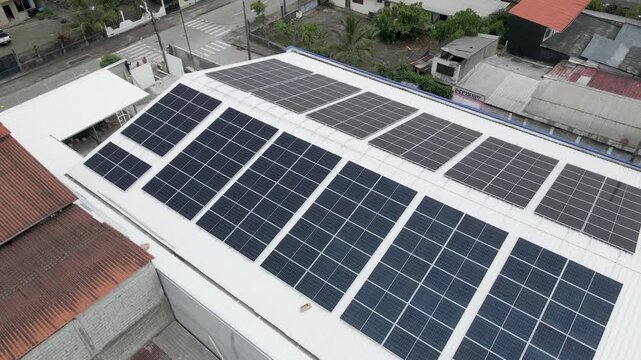 Solar panels installed on industrial warehouse roof generating renewable energy
