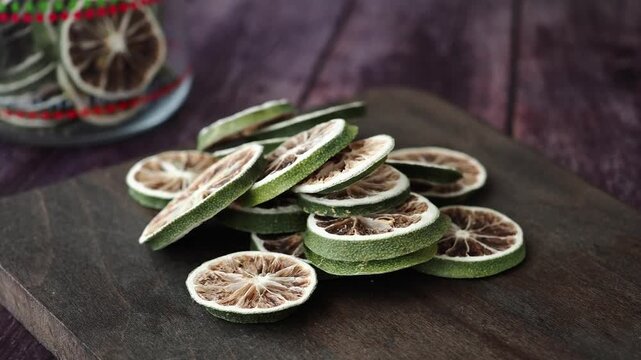 Dried lime slices on wooden table