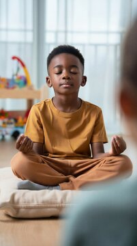Young boy mastering emotional self-regulation through guided mindfulness while a caregiver silently observes his deep focus in a home playroom.