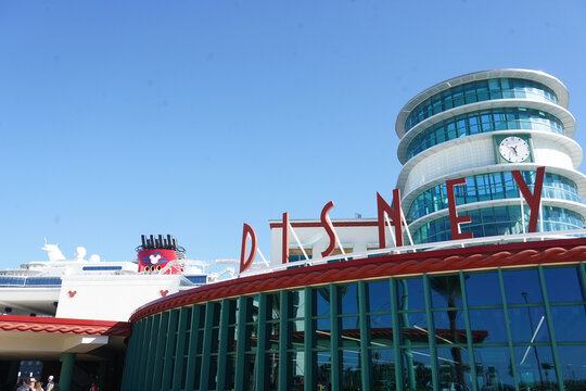 The exterior of the Disney Cruise Line port terminal with a ship in the background in the Floridian port town of Port Canaveral, Florida on December 27, 2025.