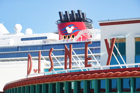 The exterior of the Disney Cruise Line port terminal with a ship in the background in the Floridian port town of Port Canaveral on December 27, 2025.