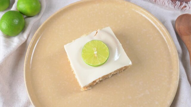 Mexican lemon dessert known as Carlota de limon with white glaze and a slice of lemon