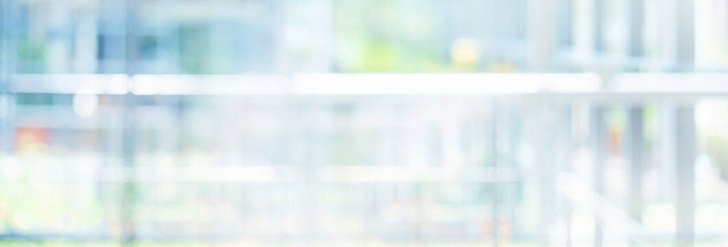 Blurred soft bokeh green nature with reflection of glass wall housing.Bright abstract background