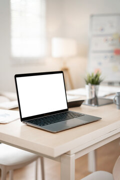 Modern laptop mockup on office wooden desk.
