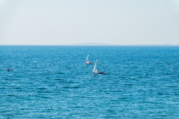 Naklejka premium Sailing yacht in the blue calm sea.