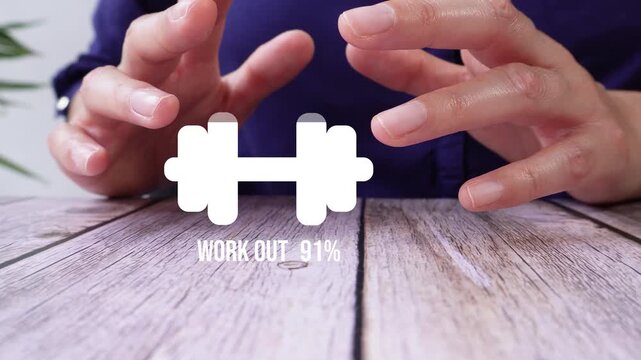 Close-up of a pair of a person's hands on a table, protecting it with their hands. A fill animation with a percentage counter of a weight and the word "Workout". 