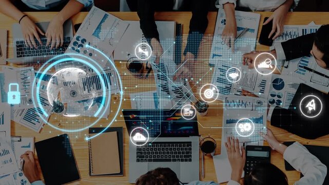 A dynamic business meeting scene showcasing team members engaged with digital analytics, charts, and technology icons for strategic planning and innovative solutions. Raster