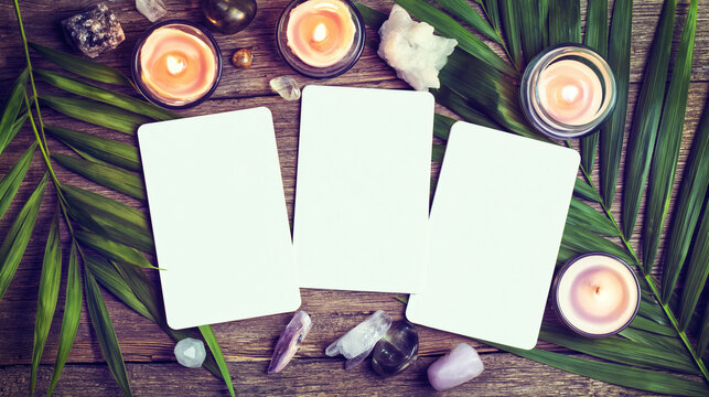 Tarot cards lie on a rustic wooden table surrounded by glowing candles and crystals.