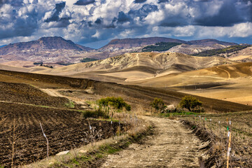 Dry mountain landscape in the Madonie Mountains, Sicily, Italy, with winding dirt track through rolling hills. © Robert