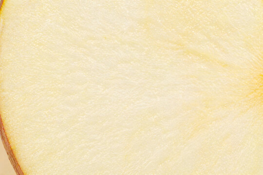 Close-up macro view of the textured flesh of a ripe yellow apple