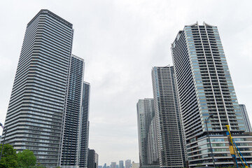 Low Angle View of High Rise Apartment Buildings Under Cloudy Sky © TYAK_FACTORY
