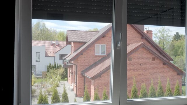 Automatic blackout blinds rising over window in room. Electric roller shutter opening on window in apartment. Concept of home privacy, sunlight control, security and exterior shading
