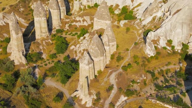 Goreme, Nevsehir, Turkey. Gorkundere Valley fairy chimneys, tall phallic tuff pillars with basalt caps, aerial panoramic view over the eroded volcanic landscape. Aerial View, MasterShots, Circle (Clo