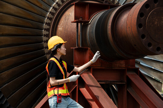 Professional engineer female working service power plant turbine fan blade electrical generator