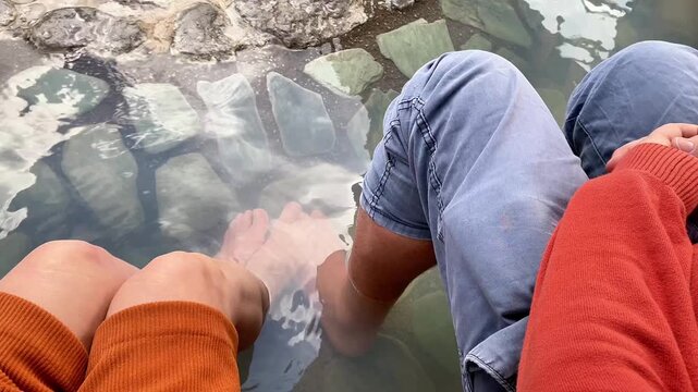  Man and Woman Enjoying a Relaxing Outdoor Thermal Foot Bath